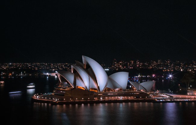 Sydney opera house lit up at night