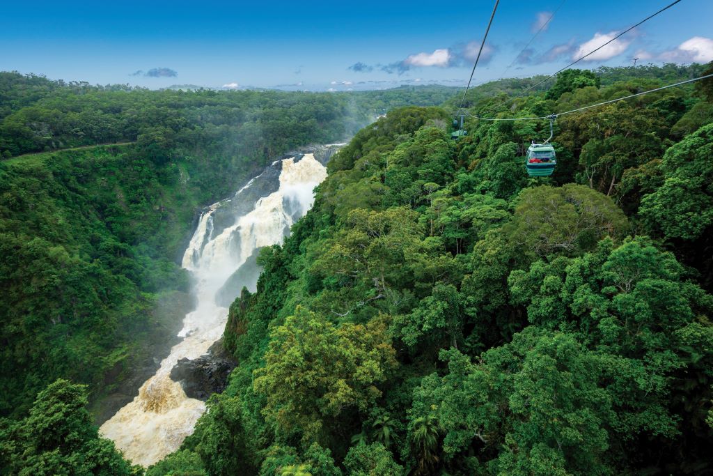 Skyrail Rainforest Cableway travelling over the rainforest canopy and Barron Gorge waterfalls, Cairns, Australia