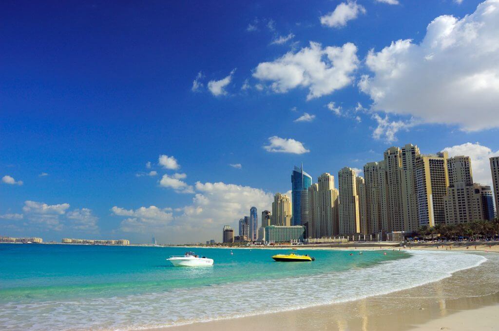 Dubai Sheraton Jumeirah Beach hotel exterior sunny sea boats cityscape