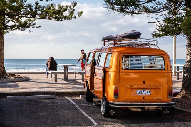 orange campervan overlooking Manly beach Australia