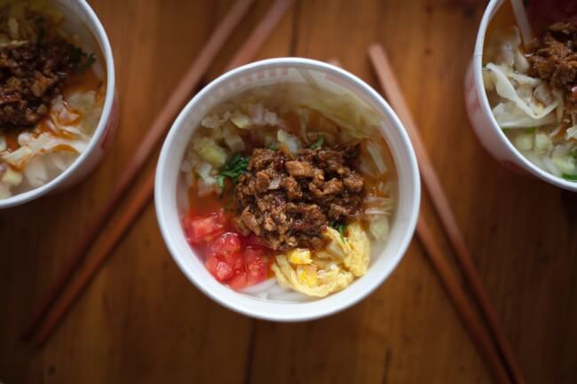 beef noodles and vegetables with chopsticks