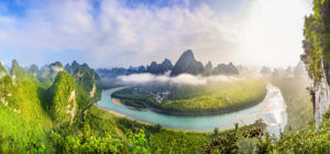 China Guilin Li River panorama landscape tropical forest scenic cloudy misty mountains