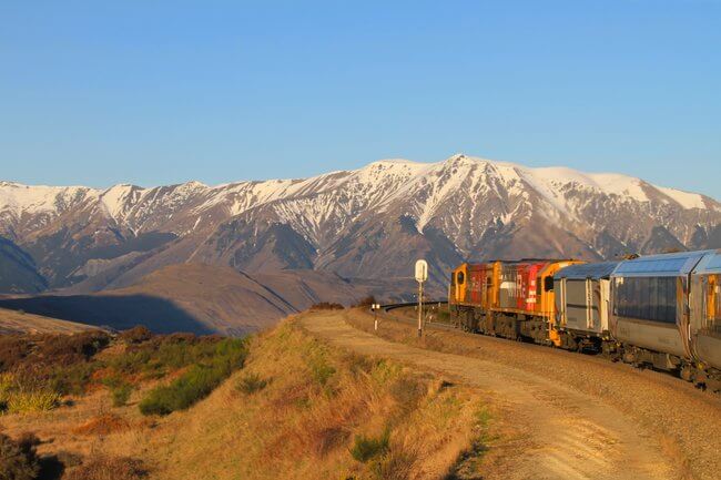 Tranz alpine train with snow capped mountains