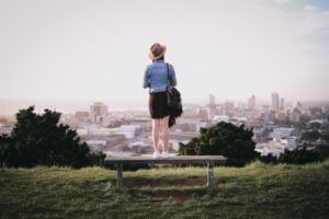 woman standing on bench over looking Auckland New Zealand