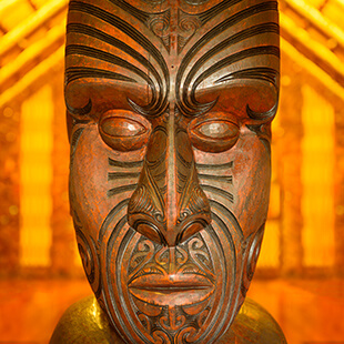 New Zealand maori wood carving of head mask intricate detail