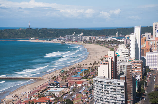 Aerial view of Durban coast, with large buildings neighbouring the golden coast