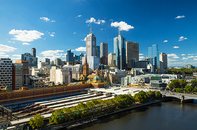 Dense Melbourne CBD with the national train station and modern Federation Square in the foreground