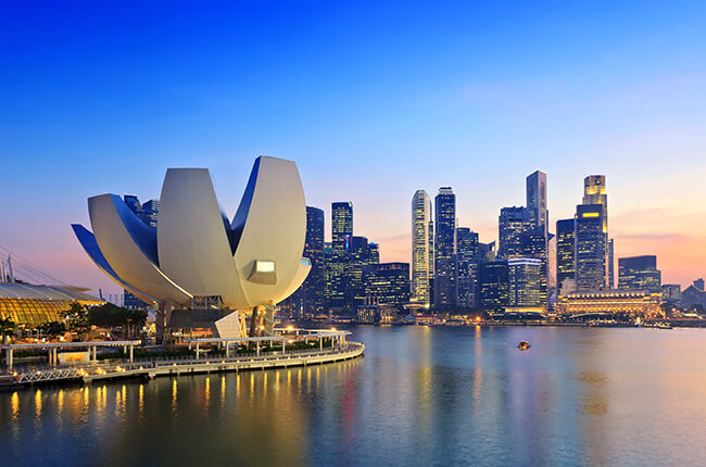 Photo of the famous Art & Science museum at the Marina Bay in Singapore, with skyscrapers behind.