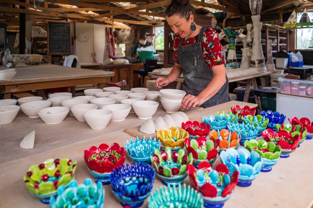 Lady making colourful craft pots in Nelson