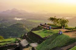 People taking in the surrounding views from the top of Sirigiya Rock, Sri Lanka