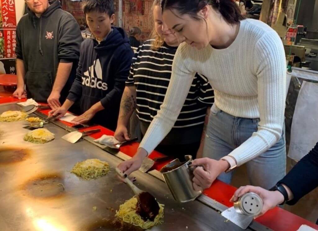 Okonomiyaki making on hot plate in Hiroshima