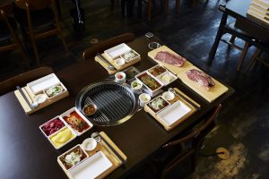 Japanese BBQ with plates set out and beef ready to cook