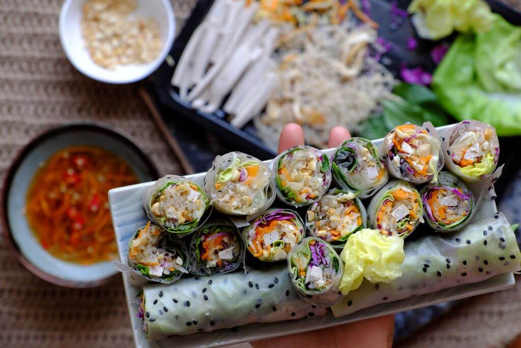 Vietnamese spring rolls on plate with ingredients in background