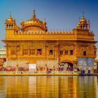 Golden Temple of Amritsar in day with reflection on water