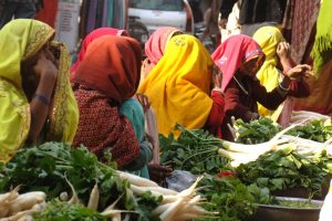 women in colourful clothes at market