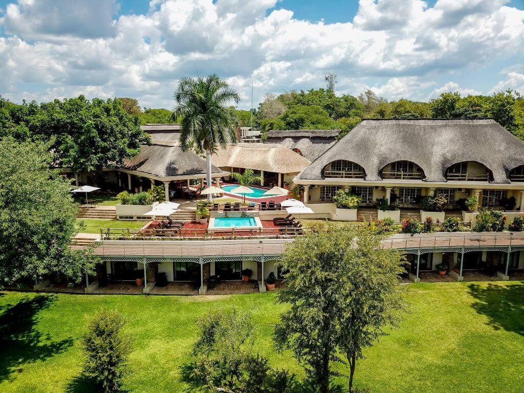 grassy area exterior Ilala lodge cloudy sky