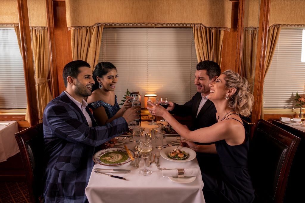 South Africa_Blue Train_Two couples toasting at dinner