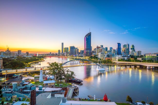 Brisbane city skyline on both sides of the river at sunset