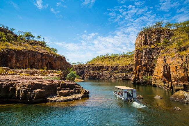 boat sailing up Katherine Gorge with clear blue skies
