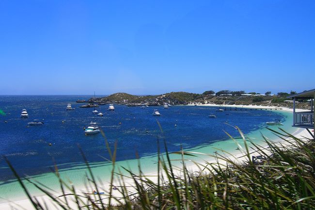 Coast of Rottnest Island with white sand and boats 