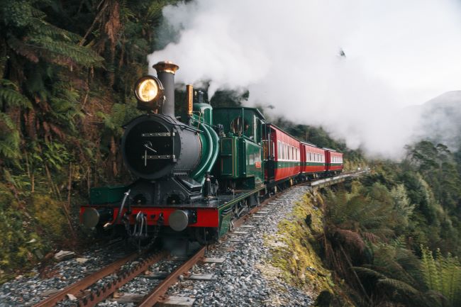 West Coast Wilderness train travelling on hiillside producing lots of steam