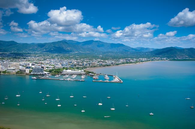 CAerial view of Cairns harbour with boats out in the sea and hills in the background