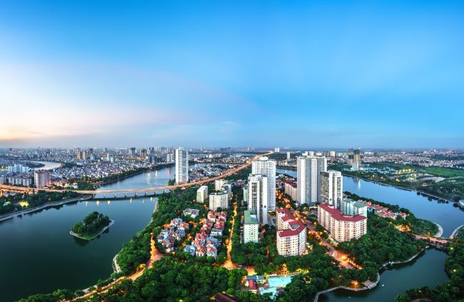 Aerial skyline of Hanoi and Linh Dam Peninsula at twilight. Vietnam