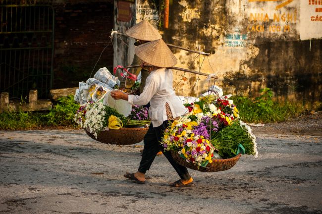 Two Vietnamese Florist Vendors in the streets of Hoi An, Vietnam