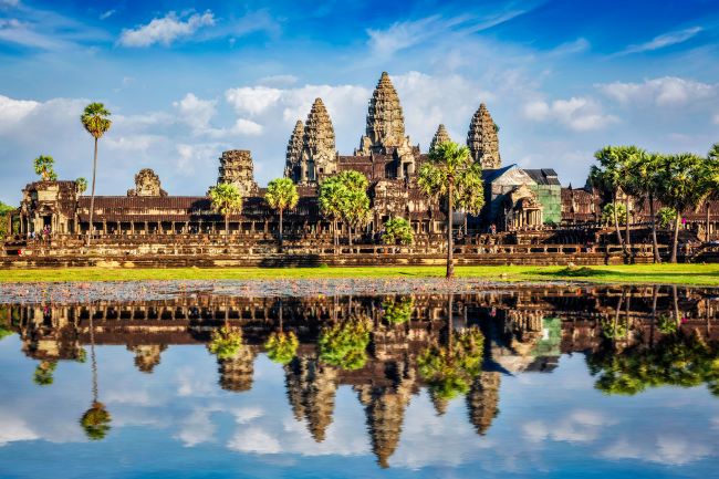 Distinctive spires of Angkor Wat near Siem Reap Cambodia against a blue sky