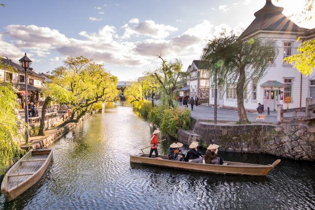 Tourists on boat in the Bikan Historical Quater, Kurashiki, Okayama Prefecture, Japan