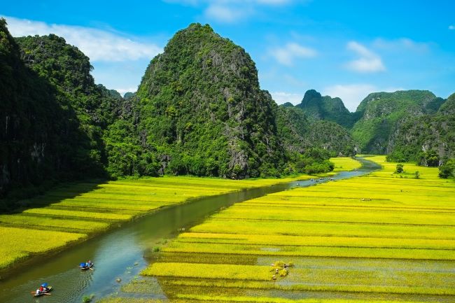 Tourists on boats in Ninh Binh known as Ha Long Bay on land in Vietnam