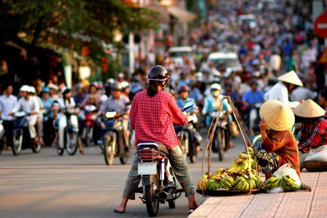 Busy Vietnamese street full of mopeds and street vendors