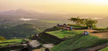 People taking in the surrounding views from the top of Sirigiya Rock, Sri Lanka