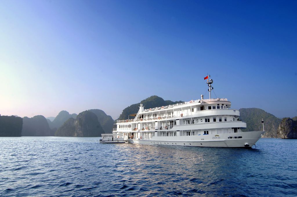 The Au Co surrounded by the beautiful towering cliffs of Ha Long Bay in Vietnam