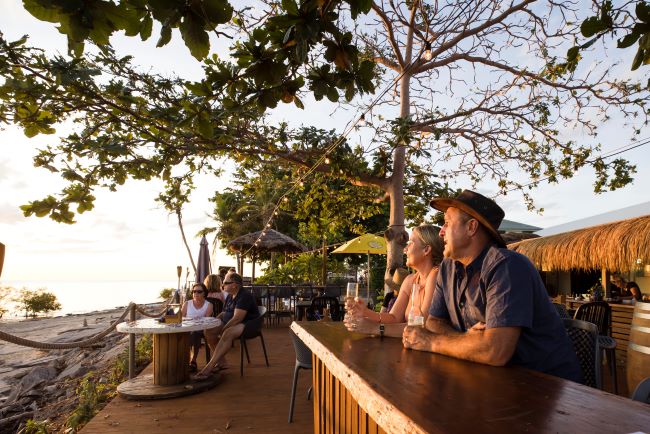 Couple enjoying a drink on Cairns Esplanade at sunset
