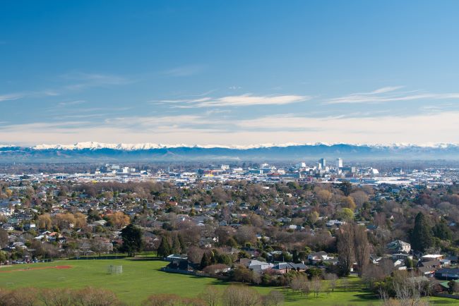 Aerial view of Christchurch, New Zealand with snow-capped mountain range in the background