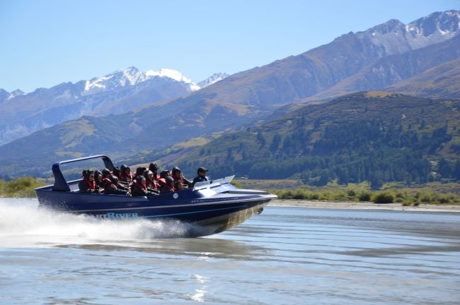Jet Boat speeding along the Dart River, near Queenstown, New Zealand