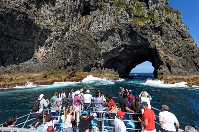 Group of tourists on Hole in the Rock cruise in the Bay of Islands, New Zealand