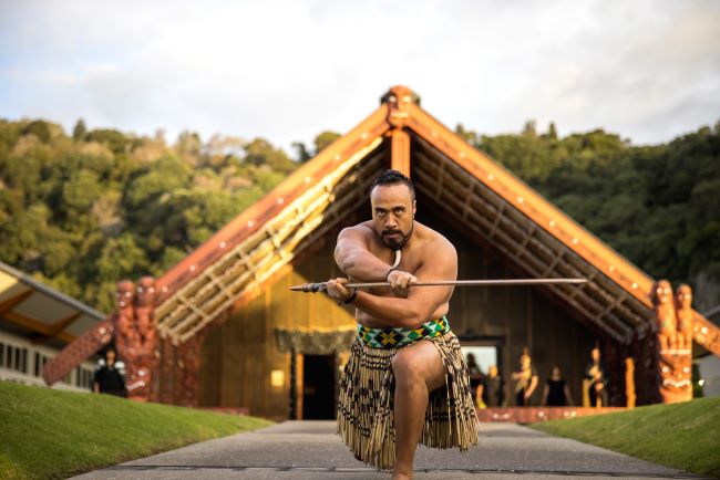 Maori in from of Meeting House, New Zealand