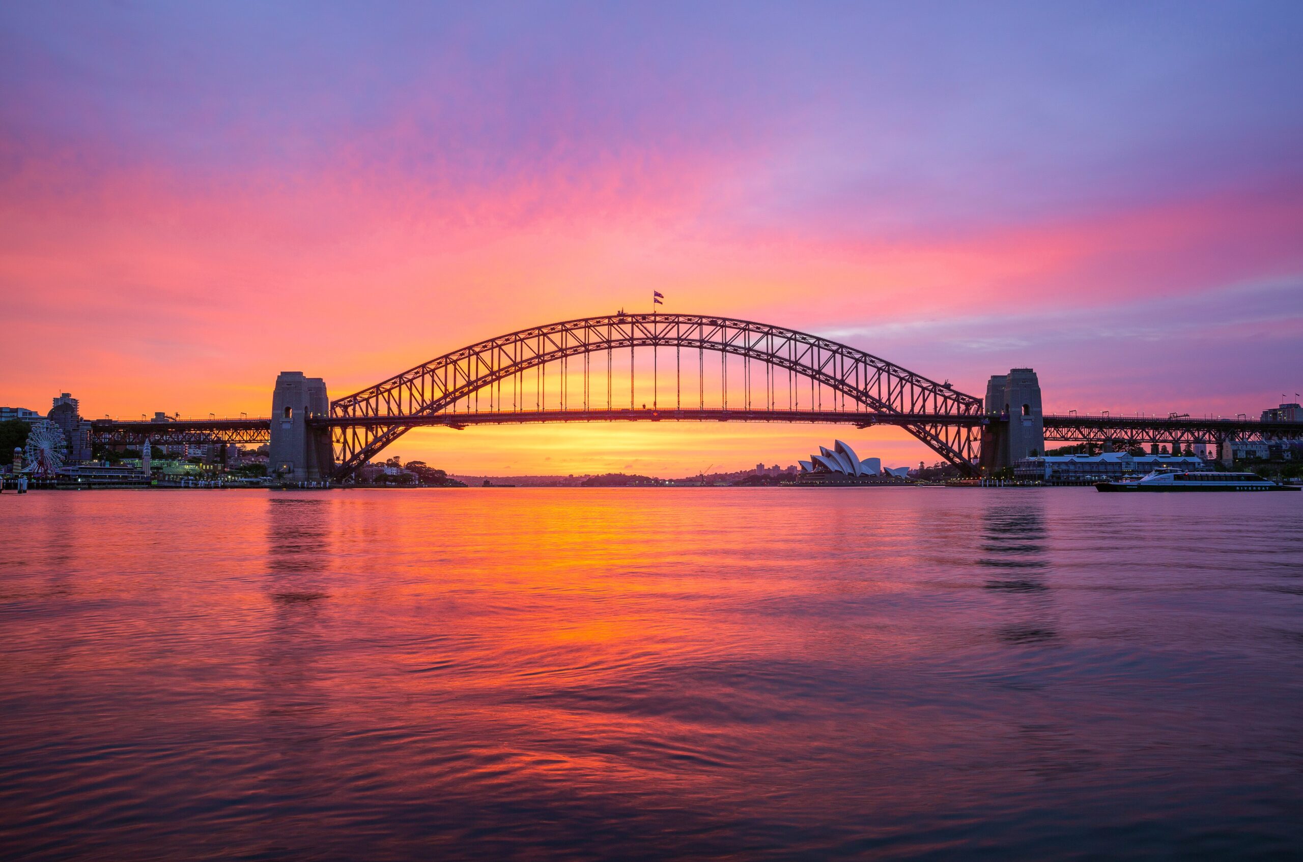 Vivid sunrise over Sydney Harbour with the Harbour Bridge and Opera House in the Background