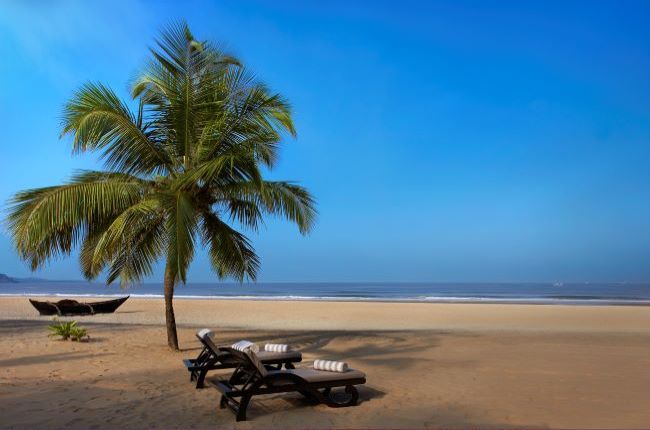 Two sunbeds with towels on a prefect golden sand beach in India