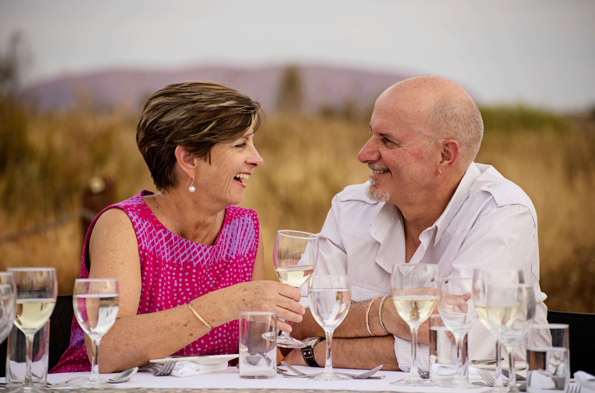 Couple celebrating with Uluru in background