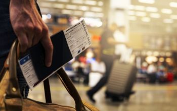 Traveller holding boarding card and passport