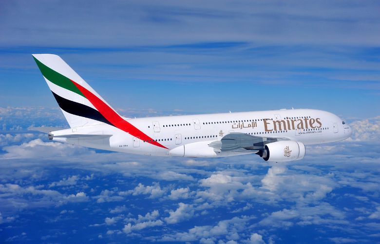 Emirates plane above the clouds