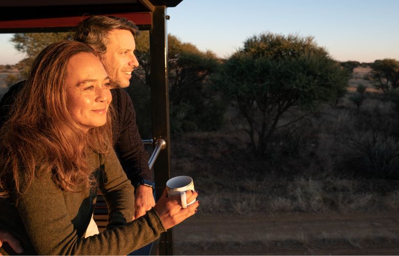 Couple looking out over the African savannah from the Observation Car on Rovos Rail