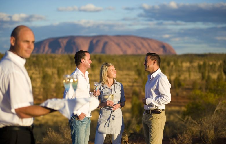 Waiter and visitors at Ayers Rock