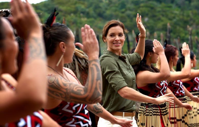 Lady dancing with Maori ladies in traditional dress in New Zealand