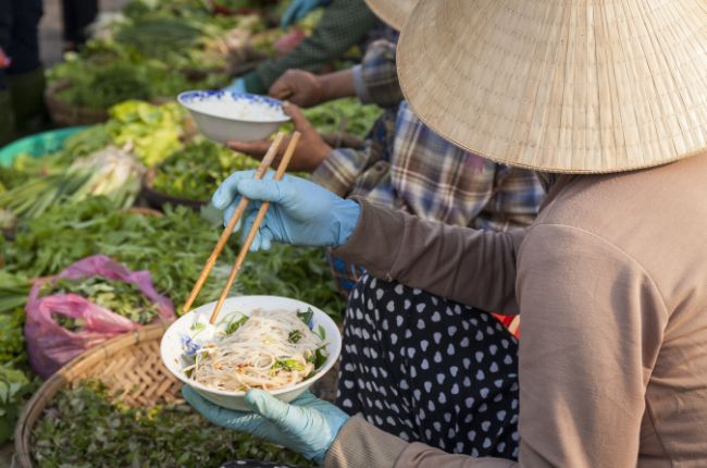 Vietnamese woman eating noodles