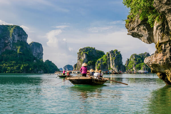 Vietnam, boats on the sea with islands in the background